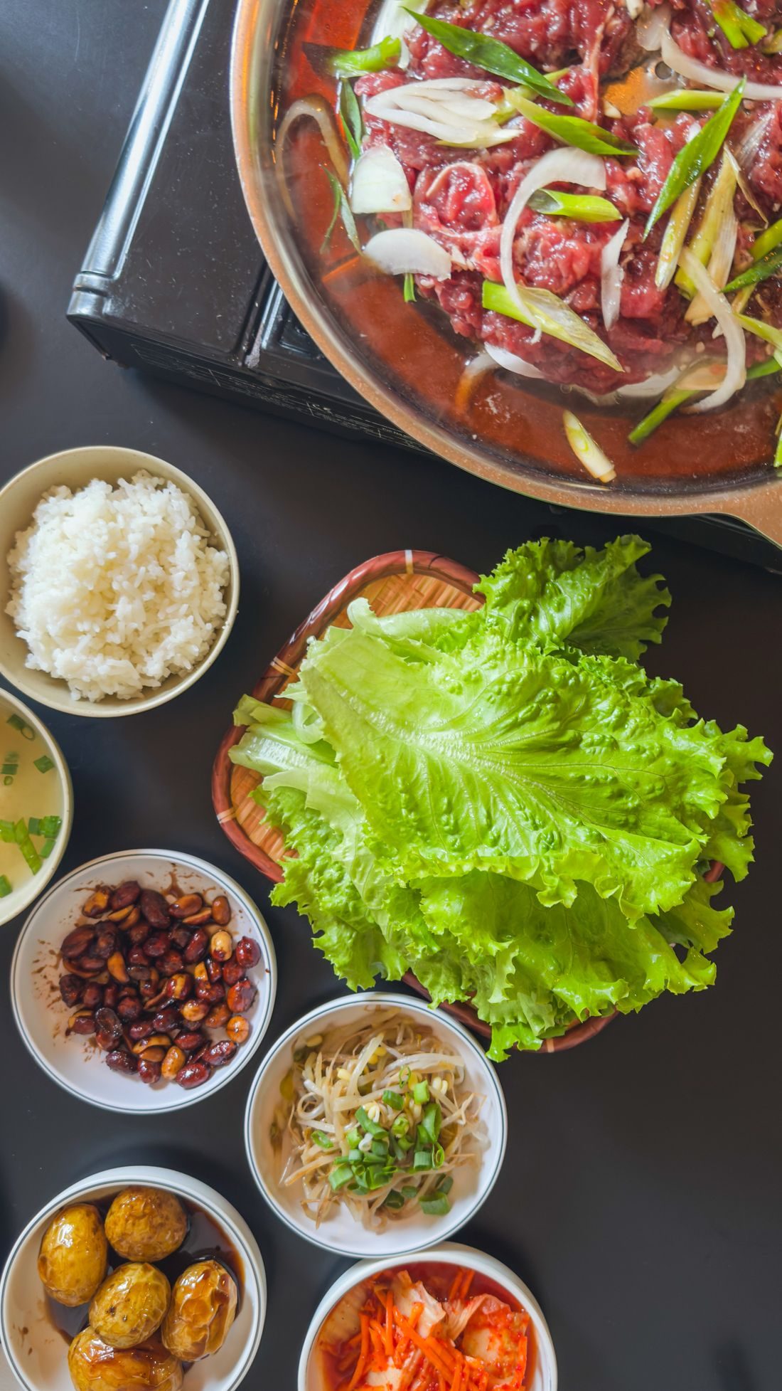 Bulgogi with lettuce and Korean side dishes